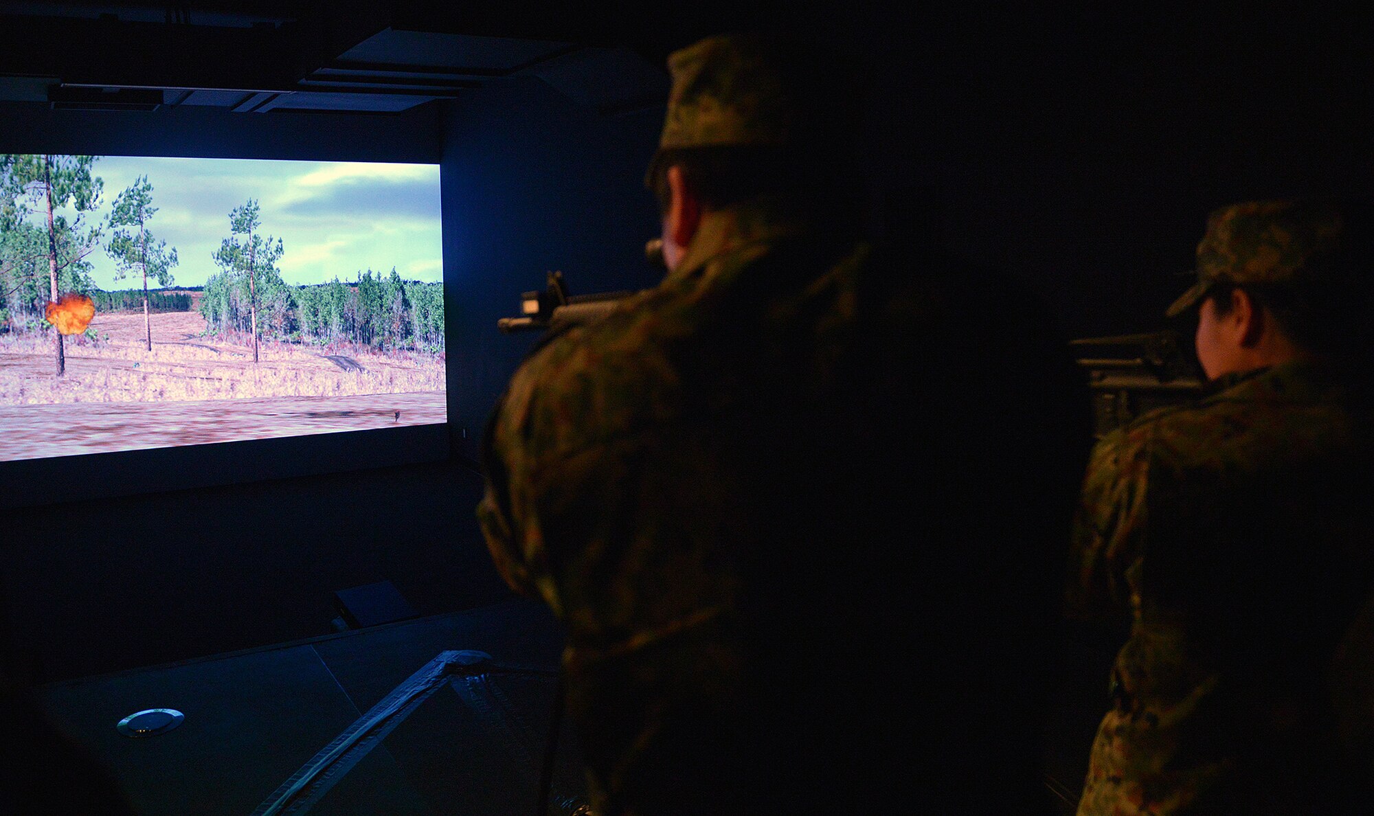 Members of the Japan Ground Self-Defense Force use the combat arms training simulator at Yokota Air Base, Japan, Feb. 6, 2014. The simulator includes both a target range and scenario based exercises used by Security Forces. (U.S. Air Force photo by Airman 1st Class David Danford/Released)