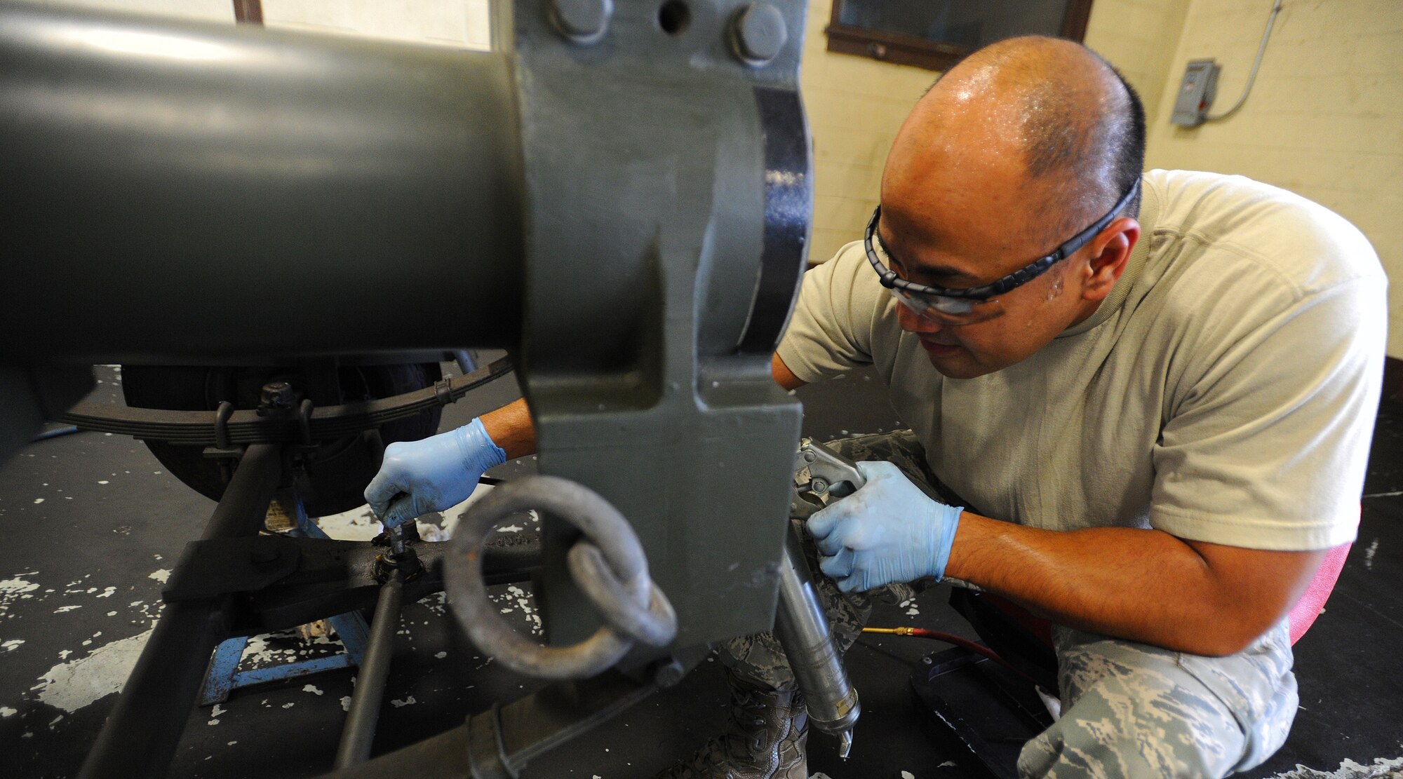Master Sgt. Rolando Layugan, 154th Maintenance Squadron aerospace ground equipment craftsman, performs routine maintenance on a boom trailer at the KC-135 AGE shop on Joint Base Pearl Harbor-Hickam, Hawaii, Feb. 6, 2014. (U.S. Air Force photo/Master Sgt. Jerome S. Tayborn)