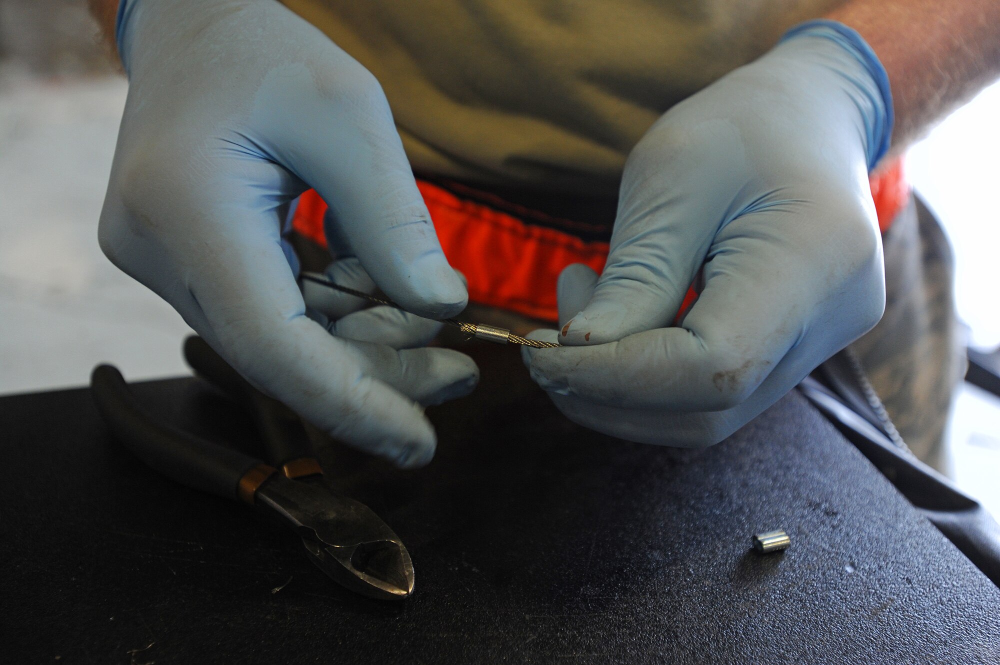 Senior Airman Joshua Braun, 15th Maintenance Squadron aerospace ground equipment journeyman, adjusts a wire fitting while performing routine maintenance on a low pressure air compressor at the KC-135 AGE shop on Joint Base Pearl Harbor-Hickam, Hawaii, Feb. 6, 2014. (U.S. Air Force photo/Master Sgt. Jerome S. Tayborn)
