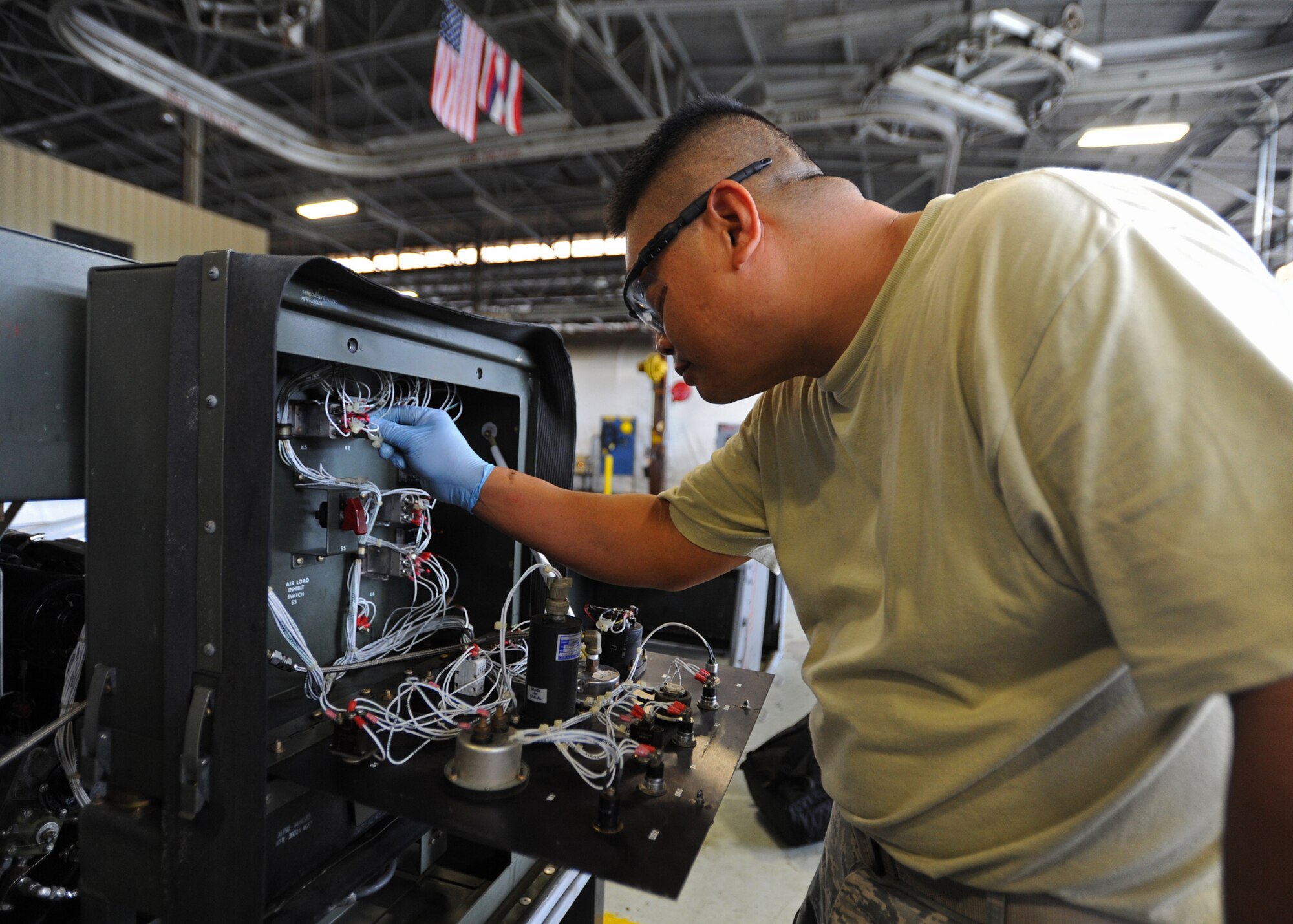 Staff Sgt. Benjamin Logalog, 154th Maintenance Squadron power support equipment systems mechanic,  checks for loose wire connections while performing a phase inspection on a power cart at the KC-135 aerospace ground equipment shop on Joint Base Pearl Harbor-Hickam, Hawaii, Feb. 6, 2014. (U.S. Air Force photo/Master Sgt. Jerome S. Tayborn)