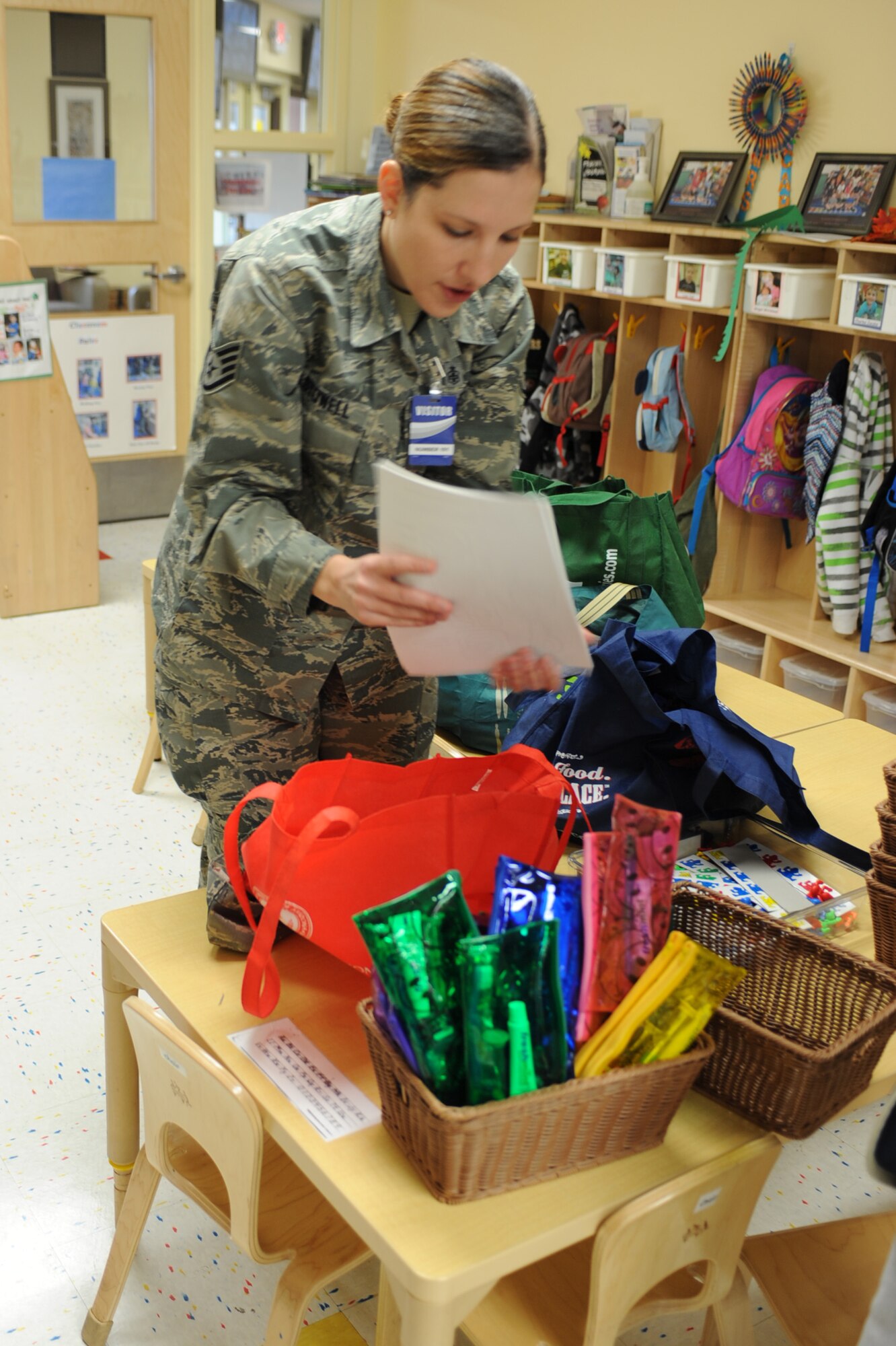 U.S. Air Force Staff Sgt. Kristy Stowell, 355th Dental Squadron dental technician, distributes toothbrush kits and coloring pages with fun dental-related activities to classrooms at the D-M Child Development Center at Davis-Monthan Air Force Base, Ariz., Feb. 3, 2014.   During the month of February, dedicated dental professionals from the 355th Dental Squadron observe National Children's Dental Health Month and highlight the importance of learning good dental health at an early age.  (U.S. Air Force photo by Airman 1st Class Chris Massey)
