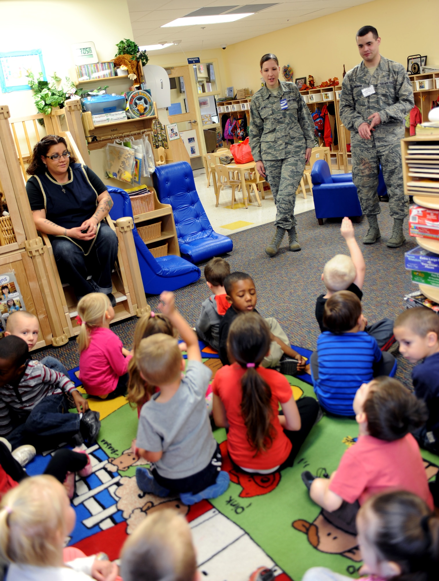 U.S. Air Force Staff Sgt.'s Kristy Stowell and Kyle Wireman, 355th Dental Squadron dental technicians, take questions and comments from children at the D-M Child Development Center during a National Children's Dental Health Month presentation at Davis-Monthan Air Force Base, Ariz., Feb. 3, 2014.  Observed since 1981,NCDHM celebrates the awareness of good oral health habits and preventative health care for children and this year's slogan is "Join the Super Smile Team."  (U.S. Air Force photo by Airman 1st Class Chris Massey)
