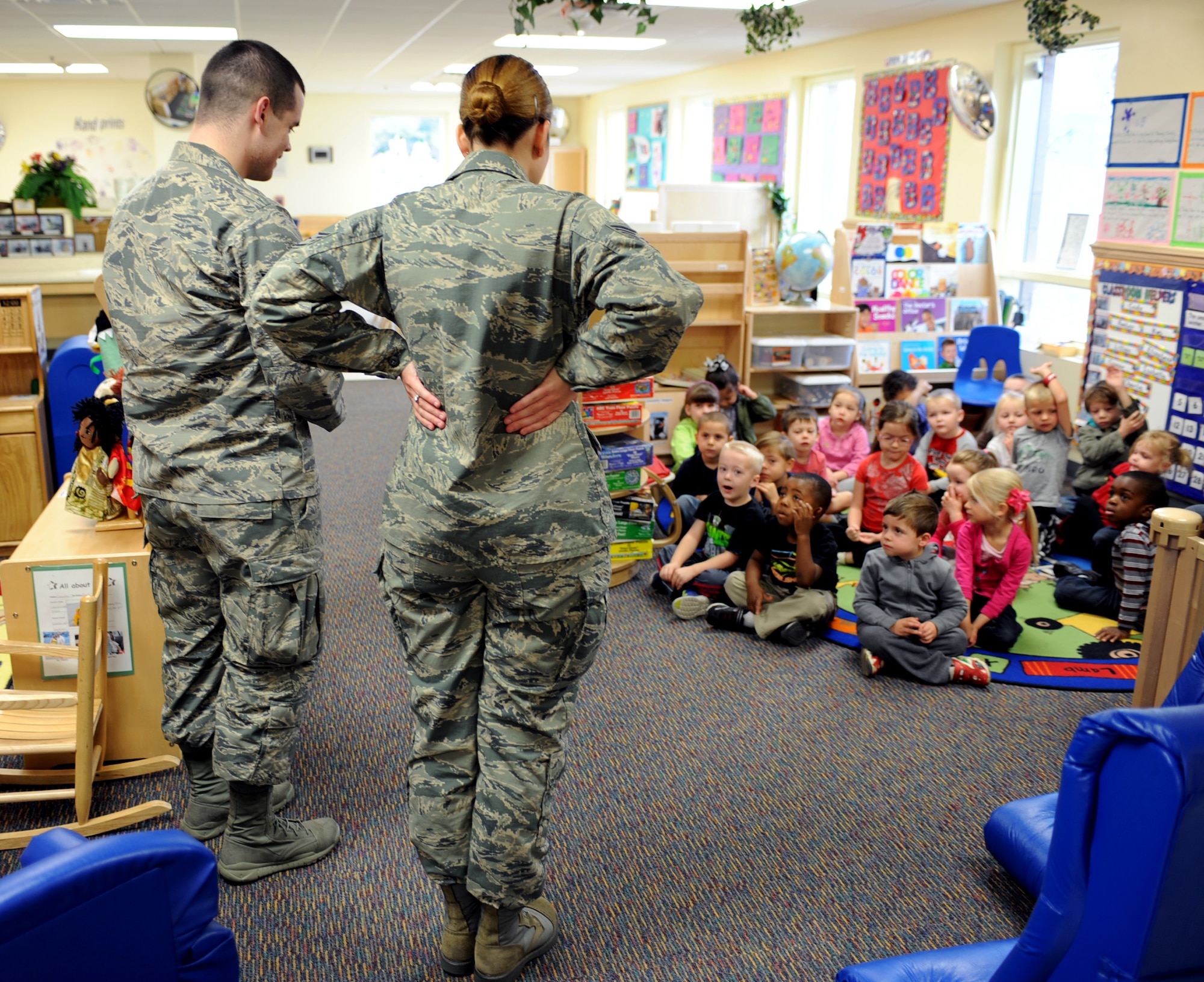 U.S. Air Force Staff Sgt.'s Kyle Wireman and Kristy Stowell, 355th Dental Squadron dental technicians, give a presentation on proper dental hygiene and healthy eating habits during a presentation at the D-M Child Development Center at Davis-Monthan Air Force Base, Ariz., Feb. 3, 2014.  Wireman and Stowell used props and activities to teach children that dental health, although important, can be fun.  (U.S. Air Force photo by Airman 1st Class Chris Massey)