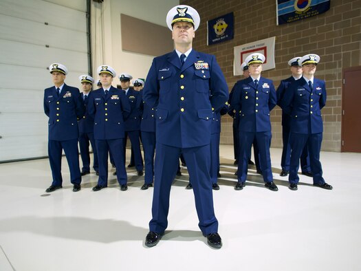 Cmdr. Sean Decker, U.S. Coast Guard Sector Anchorage chief of response and native
of Factoryville, Pa., stands at the head of the command during a ceremony welcoming
the unit to the Alaska Army National Guard Armory. (U.S. Air Force photo/David Bedard)