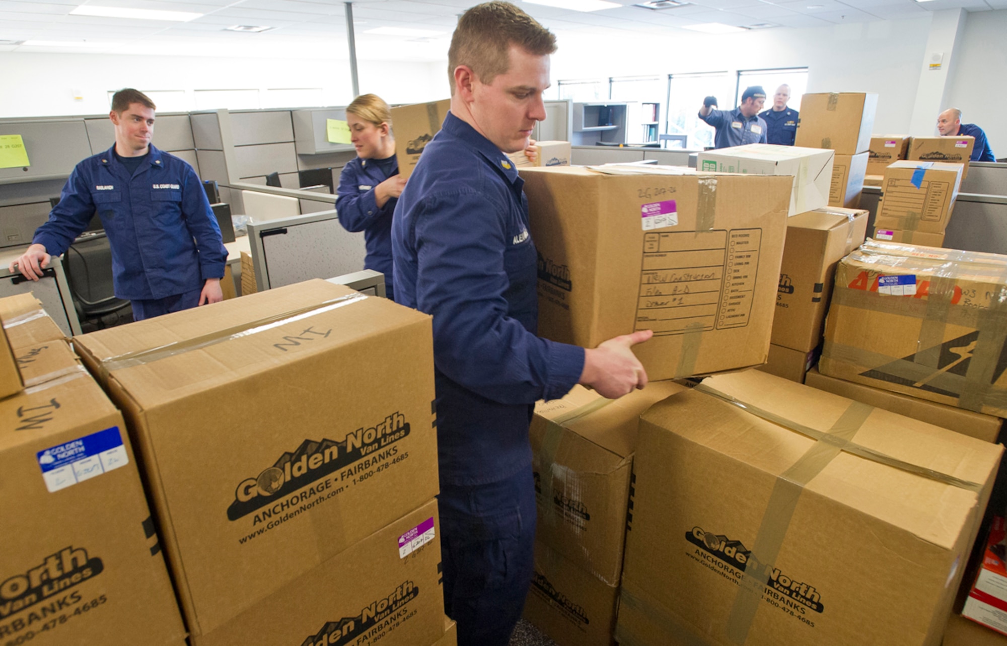 Petty Officer 1st Class John Alexander, a native of Greenbrier, Ark., assigned to U.S. Coast Guard Sector Anchorage, moves into his unit’s new headquarters at the Alaska Army National Guard armory Feb. 4. (U.S. Air Force photo/Justin Connaher)