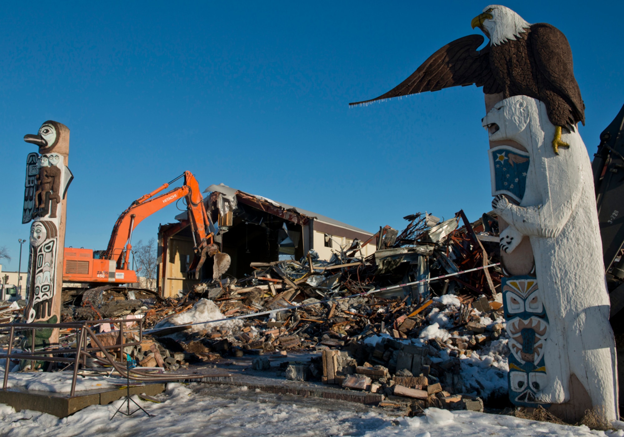 The Kashim Club is demolished Feb. 4 at Joint Base Elmendorf-Richardson after more than 50 years as a hub of entertainment for Airmen. The club was an Alaska fixture, serving as the 11th Air Force club throughout World War II, then as a club for noncommissioned officers, before opening to all ranks. The club was closed in early 2012 due to lack of business. The Air Force, in an effort to reduce infrastructure, chose to demolish the building. (U.S. Air Force photo/Tech. Sgt. Raymond Mills)