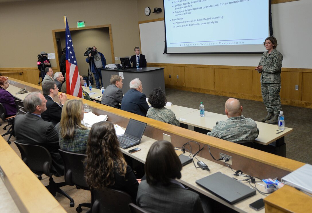Lt. Col. Susan Lynch, 28th Communications Squadron commander, briefs base and community leaders about new community partnership initiatives in the University Center at Rapid City, S.D., Jan. 30, 2014. During the event, Lynch spoke about a number of programs that base and local agencies will be utilizing in an effort to reduce operating and service costs. (U.S. Air Force photo by Senior Airman Zachary Hada/Released)