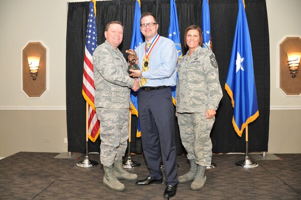 Brig. Gen. Samuel Mahaney, Air Reserve Personnel Center commander, and Chief Master Sgt. Ruthe Flores, ARPC command chief, present the Category II, Supervisory Civilian of the Year award to Michael Ballinger. Mahaney honored ARPC’s 2013 outstanding performers of the year as well as their A1 annual award winners at the Summit Conference and Event Center Feb. 6, 2014, in Denver. (U.S. Air Force photo/Tech. Sgt. Rob Hazelett) 