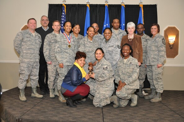Brig. Gen. Samuel Mahaney, Air Reserve Personnel Center commander, and Chief Master Sgt. Ruthe Flores, ARPC command chief, present the Team of the Year award to the assignments branch team. Mahaney honored ARPC’s 2013 outstanding performers of the year as well as their A1 annual award winners at the Summit Conference and Event Center Feb. 6, 2014, in Denver. (U.S. Air Force photo/Tech. Sgt. Rob Hazelett)