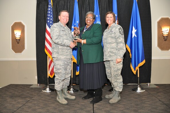 Brig. Gen. Samuel Mahaney, Air Reserve Personnel Center commander, and Chief Master Sgt. Ruthe Flores, ARPC command chief, present the Category II, Non-Supervisory Civilian of the Year award to Reniese Johnson. Mahaney honored ARPC’s 2013 outstanding performers of the year as well as their A1 annual award winners at the Summit Conference and Event Center Feb. 6, 2014, in Denver. (U.S. Air Force photo/Tech. Sgt. Rob Hazelett)