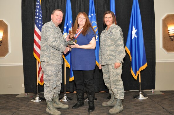 Brig. Gen. Samuel Mahaney, Air Reserve Personnel Center commander, and Chief Master Sgt. Ruthe Flores, ARPC command chief, present the Category I, Non-Supervisory Civilian of the Year award to Donna Burton. Mahaney honored ARPC’s 2013 outstanding performers of the year as well as their A1 annual award winners at the Summit Conference and Event Center Feb. 6, 2014, in Denver. (U.S. Air Force photo/Tech. Sgt. Rob Hazelett)