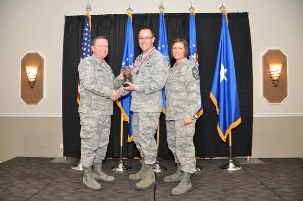 Brig. Gen. Samuel Mahaney, Air Reserve Personnel Center commander, and Chief Master Sgt. Ruthe Flores, ARPC command chief, present the ARPC Company Grade Officer of the Year award to Capt. Andrew Williams. Mahaney honored ARPC’s 2013 outstanding performers of the year as well as their A1 annual award winners at the Summit Conference and Event Center Feb. 6, 2014, in Denver. (U.S. Air Force photo/Tech. Sgt. Rob Hazelett)