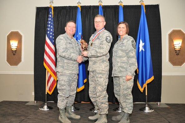 Brig. Gen. Samuel Mahaney, Air Reserve Personnel Center commander, and Chief Master Sgt. Ruthe Flores, ARPC command chief, present the ARPC Senior Noncommissioned Officer of the Year award to Master Sgt. Sean Landing. Mahaney honored ARPC’s 2013 outstanding performers of the year as well as their A1 annual award winners at the Summit Conference and Event Center Feb. 6, 2014, in Denver. (U.S. Air Force photo/Tech. Sgt. Rob Hazelett)