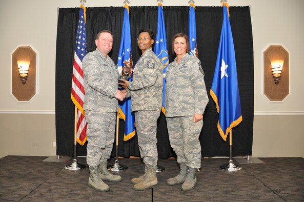 Brig. Gen. Samuel Mahaney, Air Reserve Personnel Center commander, and Chief Master Sgt. Ruthe Flores, ARPC command chief, present the ARPC Noncommissioned Officer of the Year award to Tech. Sgt. Leticia Edwards. Mahaney honored ARPC’s 2013 outstanding performers of the year as well as their A1 annual award winners at the Summit Conference and Event Center Feb. 6, 2014, in Denver. (U.S. Air Force photo/Tech. Sgt. Rob Hazelett)