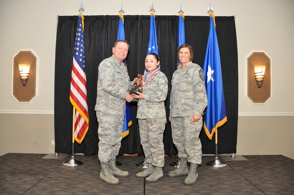 Brig. Gen. Samuel Mahaney, Air Reserve Personnel Center commander, and Chief Master Sgt. Ruthe Flores, ARPC command chief, present the ARPC Airman of the Year award to Senior Airman Brandi Blea. Mahaney honored ARPC’s 2013 outstanding performers of the year as well as their A1 annual award winners at the Summit Conference and Event Center Feb. 6, 2014, in Denver. (U.S. Air Force photo/Tech. Sgt. Rob Hazelett)