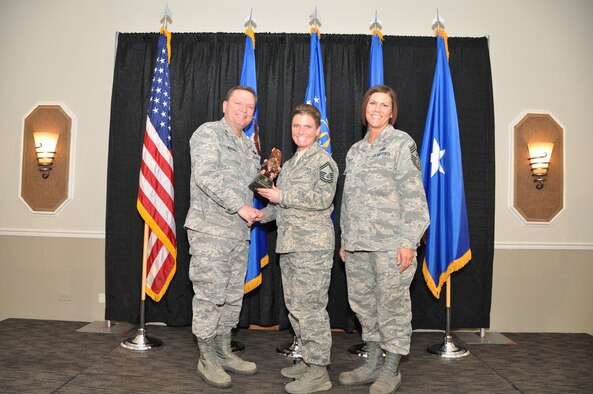 Brig. Gen. Samuel Mahaney, Air Reserve Personnel Center commander, and Chief Master Sgt. Ruthe Flores, ARPC command chief, present the ARPC Honor Guard Member of the Year award to Senior Master Sgt. Stacy Wilfong, who accepted the award in place of Staff Sgt. Ashley Correa. Mahaney honored ARPC’s 2013 outstanding performers of the year as well as their A1 annual award winners at the Summit Conference and Event Center Feb. 6, 2014, in Denver. (U.S. Air Force photo/Tech. Sgt. Rob Hazelett)