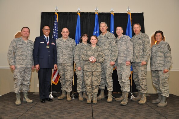 Brig. Gen. Samuel Mahaney, Air Reserve Personnel Center commander, and Chief Master Sgt. Ruthe Flores, ARPC command chief, present the A1 Special Recognition Team and Program of the Year award to the Force Development team. Mahaney honored ARPC’s 2013 outstanding performers of the year as well as their A1 annual award winners at the Summit Conference and Event Center Feb. 6, 2014, in Denver. (U.S. Air Force photo/Tech. Sgt. Rob Hazelett)