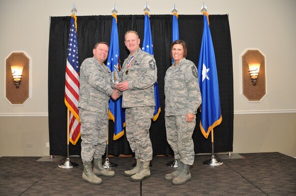 Brig. Gen. Samuel Mahaney, Air Reserve Personnel Center commander, and Chief Master Sgt. Ruthe Flores, ARPC command chief, present the General Michael P.C. Carns Award to Senior Master Sgt. Ryan Phipps. Mahaney honored ARPC’s 2013 outstanding performers of the year as well as their A1 annual award winners at the Summit Conference and Event Center Feb. 6, 2014, in Denver. (U.S. Air Force photo/Tech. Sgt. Rob Hazelett)