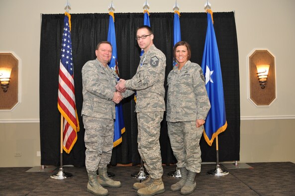 Brig. Gen. Samuel Mahaney, Air Reserve Personnel Center commander, and Chief Master Sgt. Ruthe Flores, ARPC command chief, present the Dr. Edwin C. Peterson Education and Training Manager Award to Master Sgt. Derek Perrault. Mahaney honored ARPC’s 2013 outstanding performers of the year as well as their A1 annual award winners at the Summit Conference and Event Center Feb. 6, 2014, in Denver. (U.S. Air Force photo/Tech. Sgt. Rob Hazelett)