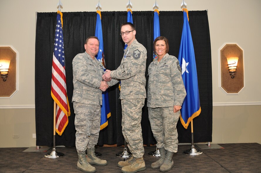 Brig. Gen. Samuel Mahaney, Air Reserve Personnel Center commander, and Chief Master Sgt. Ruthe Flores, ARPC command chief, present the Dr. Edwin C. Peterson Education and Training Manager Award to Master Sgt. Derek Perrault. Mahaney honored ARPC’s 2013 outstanding performers of the year as well as their A1 annual award winners at the Summit Conference and Event Center Feb. 6, 2014, in Denver. (U.S. Air Force photo/Tech. Sgt. Rob Hazelett)