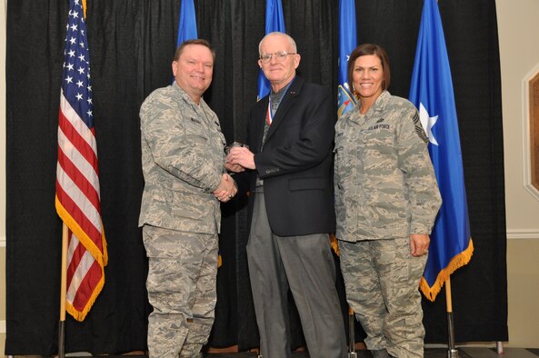 Brig. Gen. Samuel Mahaney, Air Reserve Personnel Center commander, and Chief Master Sgt. Ruthe Flores, ARPC command chief, present the Civilian Manager of the Year award to Les Brockman. Mahaney honored ARPC’s 2013 outstanding performers of the year as well as their A1 annual award winners at the Summit Conference and Event Center Feb. 6, 2014, in Denver. (U.S. Air Force photo/Tech. Sgt. Rob Hazelett)