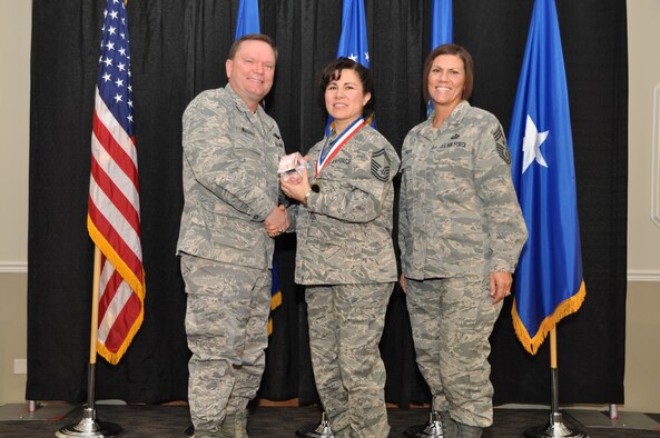Brig. Gen. Samuel Mahaney, Air Reserve Personnel Center commander, and Chief Master Sgt. Ruthe Flores, ARPC command chief, present the Force Support Force Support Senior Noncommissioned Officer of the Year, Air Reserve Component award to Senior Master Sgt. Monica Ramirez. Mahaney honored ARPC’s 2013 outstanding performers of the year at the Summit Conference and Event Center Feb. 6, 2014, in Denver. (U.S. Air Force photo/Tech. Sgt. Rob Hazelett)