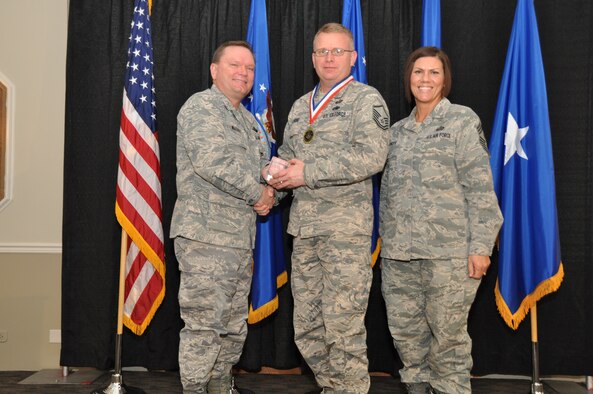 Brig. Gen. Samuel Mahaney, Air Reserve Personnel Center commander, and Chief Master Sgt. Ruthe Flores, ARPC command chief, present the Force Support Force Support Senior Noncommissioned Officer of the Year to Master Sgt. Sean Landing. Mahaney honored ARPC’s 2013 outstanding performers of the year at the Summit Conference and Event Center Feb. 6, 2014, in Denver. (U.S. Air Force photo/Tech. Sgt. Rob Hazelett)