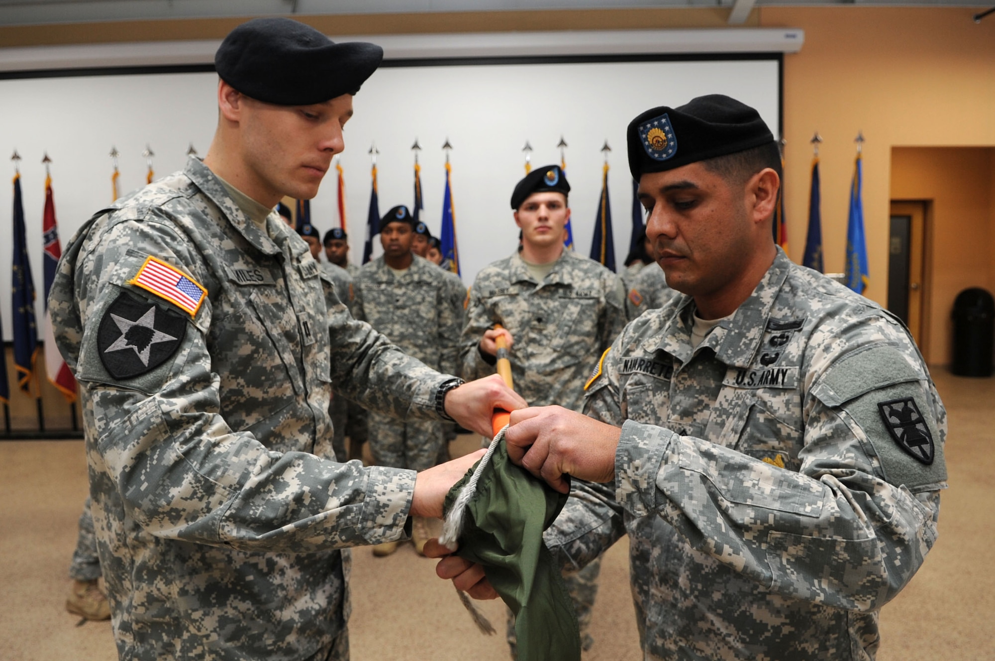 U.S. Army Capt. Richard Miles, 235th Signal Company, Special Troops Battalion, 7th Transportation Brigade (Expeditionary) commander, and 1st Sgt. Eliseo Navarrete, 235th Sig. Co. first sergeant, case the colors of the 235th Sig. Co. during an inactivation ceremony at Fort Eustis, Va., Jan. 31, 2014.  The unit was assigned to Fort Eustis on May 16, 2012.  (U.S. Air Force photo by Airman 1st Class Austin Harvill/Released)