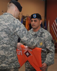U.S. Army 1st Sgt. Eliseo Navarrete, 235th Signal Company, Special Troops Battalion, 7th Transportation Brigade (Expeditionary) first sergeant, cases the colors of the 235th Sig. Co. with Capt. Richard Miles, 235th Sig. Co. commander during an inactivation ceremony at Fort Eustis, Va., Jan. 31, 2014. As a result of the changes in the 7th Trans. Bde., multiple units are inactivating since their missions do not fall under transportation. (U.S. Air Force photo by Staff Sgt. Katie Gar Ward/Released)