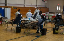 Donors roll up their sleeves during the American Red Cross blood drive Feb. 5, 2014, at Joint Base Charleston - Air Base, S.C. The donated blood will be sent to a Red Cross blood component laboratory where it will be processed into several components; red blood cells, plasma, platelets and/or cryoprecipitate. A single blood donation may help up to three different people. (U.S. Air Force photo/Senior Airman Ashlee Galloway)