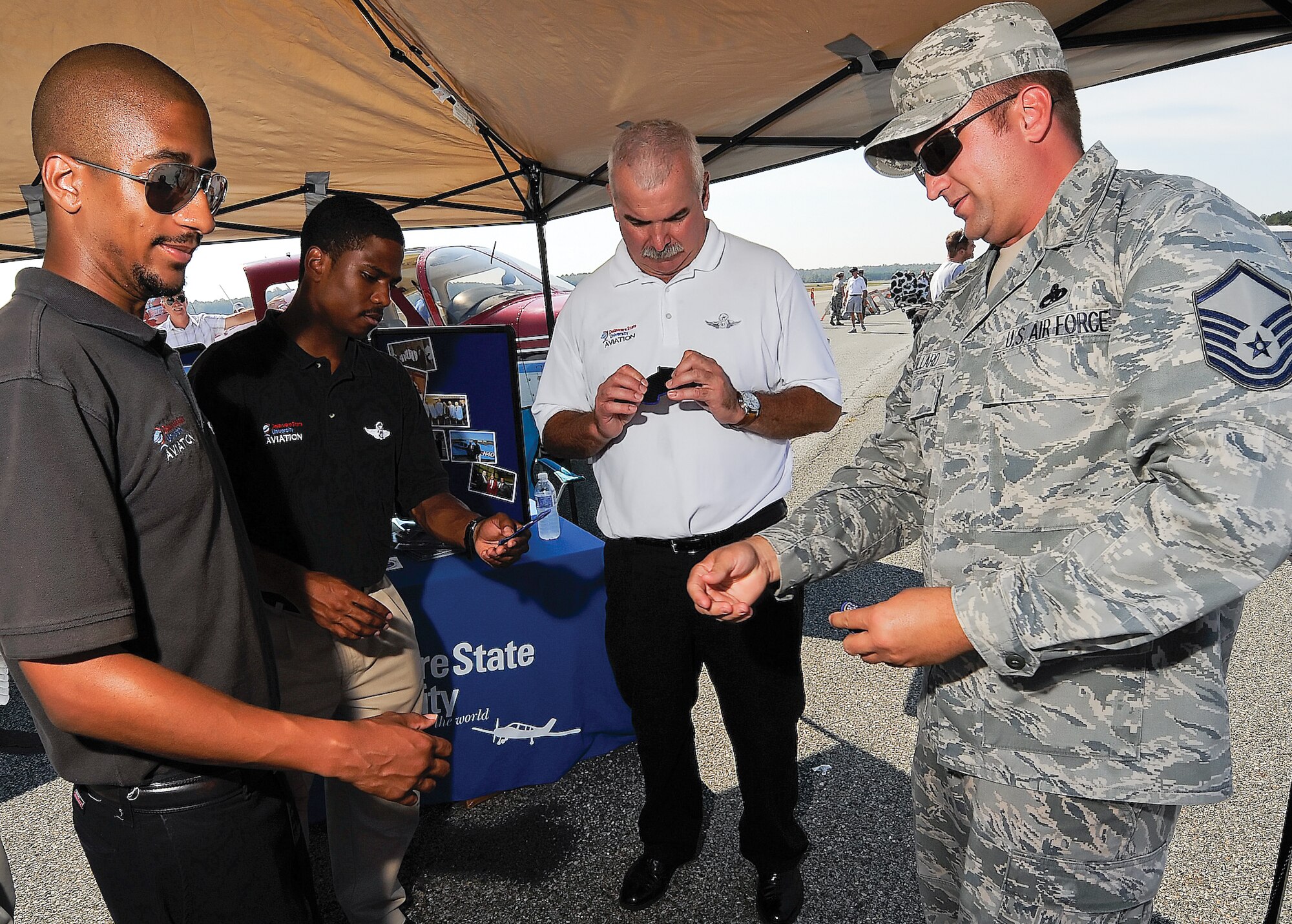 MSgt John Willard talks with Delaware State University flying program staff about aircraft safety and midair collision avoidance at the Georgetown, Del. air show.