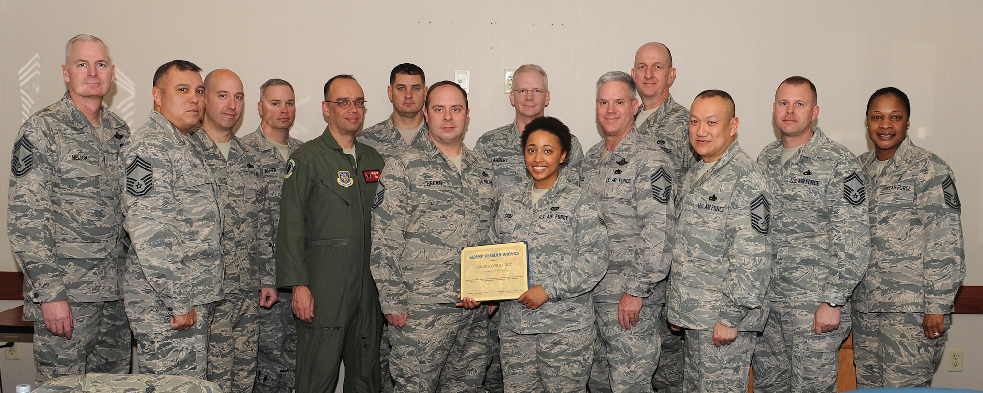 Senior Airman Socorro Cruz, a 314th Operations Group intelligence analyst, is awarded the Chief’s Group Sharp Troop Award Feb. 4, 2014, at Little Rock Air Force Base, Ark.  Cruz supported two operations, squadrons conducting 25 pre-mission crew briefings to more than 150 formal training unit students. (U.S. Air Force photo by Tech. Sgt. Chad Chisholm)