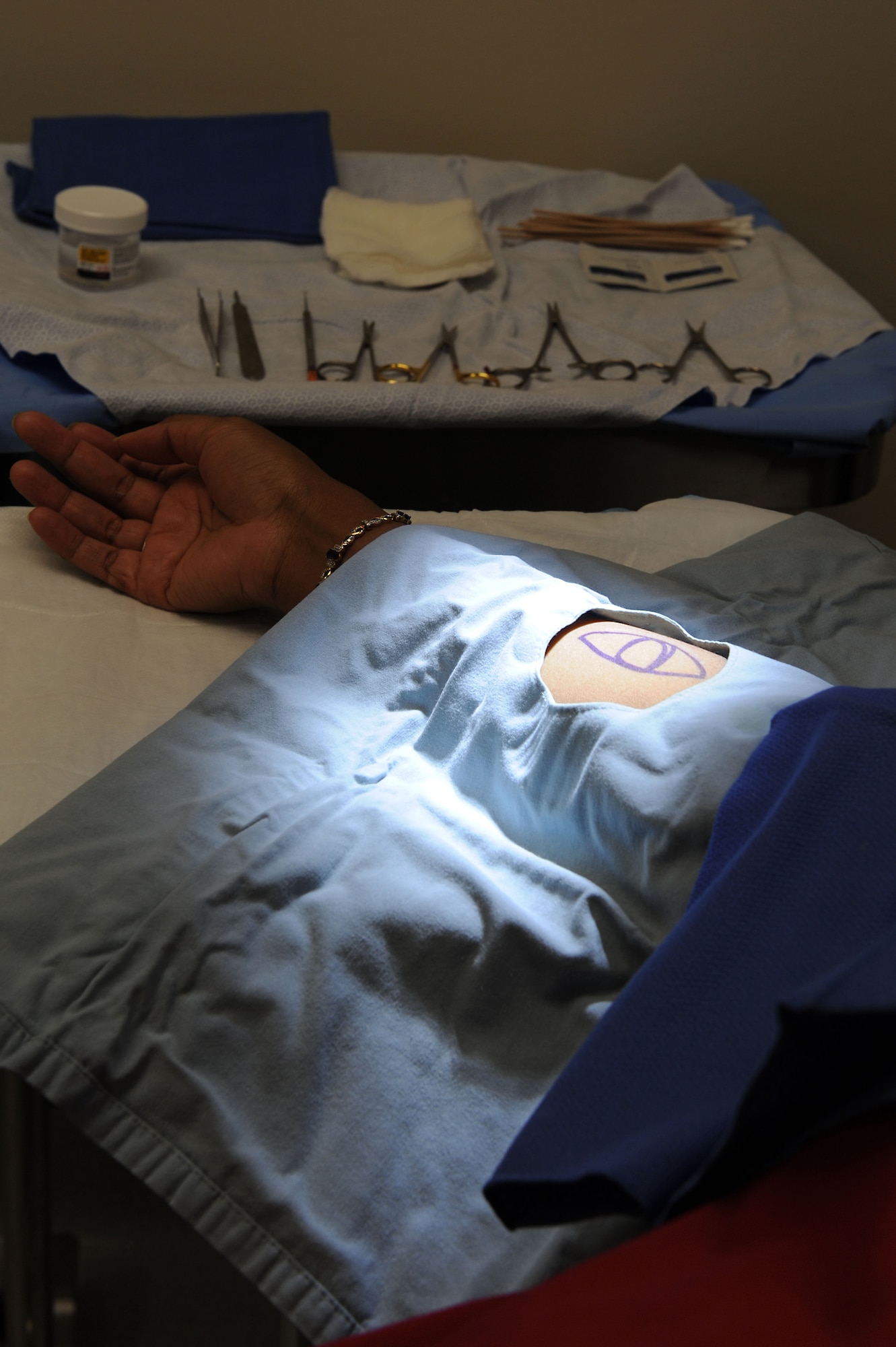 Cynthia Paige, 633rd Medical Operations Squadron medical technician, awaits a routine procedure at Langley Air Force Base, Va., Feb. 4, 2014. The U.S. Air Force Hospital Langley Dermatology clinic treats common conditions of the skin such as psoriasis, eczema, moles, skin infections, rashes and skin growths. Paige hails from Baltimore, Md. (U.S. Air Force photo by Senior Airman Brittany Paerschke-O’Brien/Released)