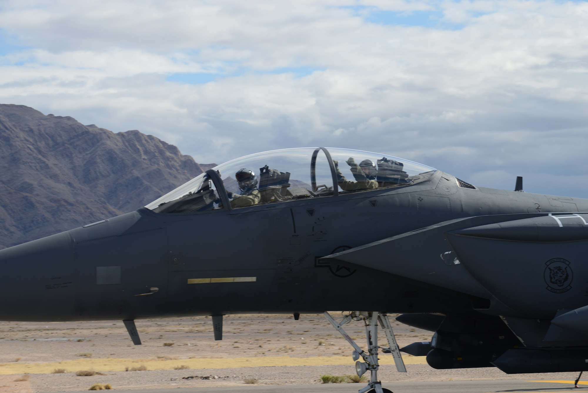 Col. Chris Short, 366th Fighter Wing commander, and Capt. Bernard Froehlich, 391st Fighter Squadron weapon systems officer, both from Mountain Home Air Force Base, Idaho, fire themselves up for a Red Flag sortie while taxiing on the flight line Jan. 31, 2014, at Nellis Air Force Base, Nev. Short and Froehlich operate the F-15E Strike Eagle which has the capability to perform air-to-air or air-to-ground missions at all altitudes, day or night, in any weather. (U.S. Air Force photo by Senior Airman Benjamin Sutton/Released) 