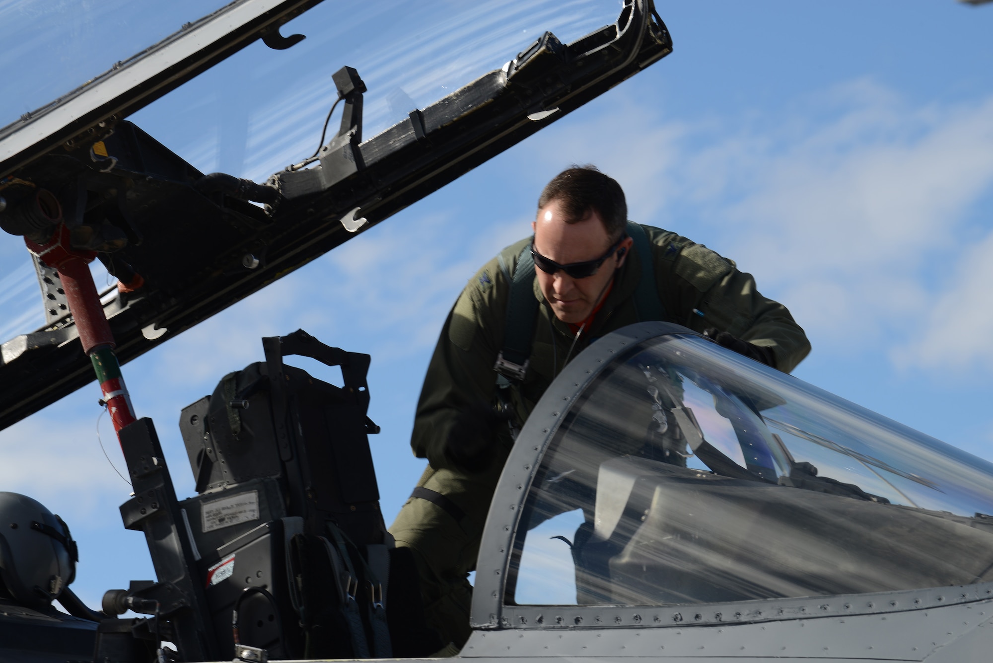 Col. Chris Short, 366th Fighter Wing commander from Mountain Home Air Force Base, Idaho, climbs into the cockpit of an F-15E Strike Eagle Jan. 31, 2014, at Nellis Air Force Base, Nev. Short is one of more than 3,200 service members participating in Red Flag 14-1. By providing realistic combat training in a contested, degraded and operationally limited environment, Red Flag 14-1 provides pilots with real-time war scenarios and helps ground crews test their readiness capabilities. (U.S. Air Force photo by Senior Airman Benjamin Sutton/Released)
