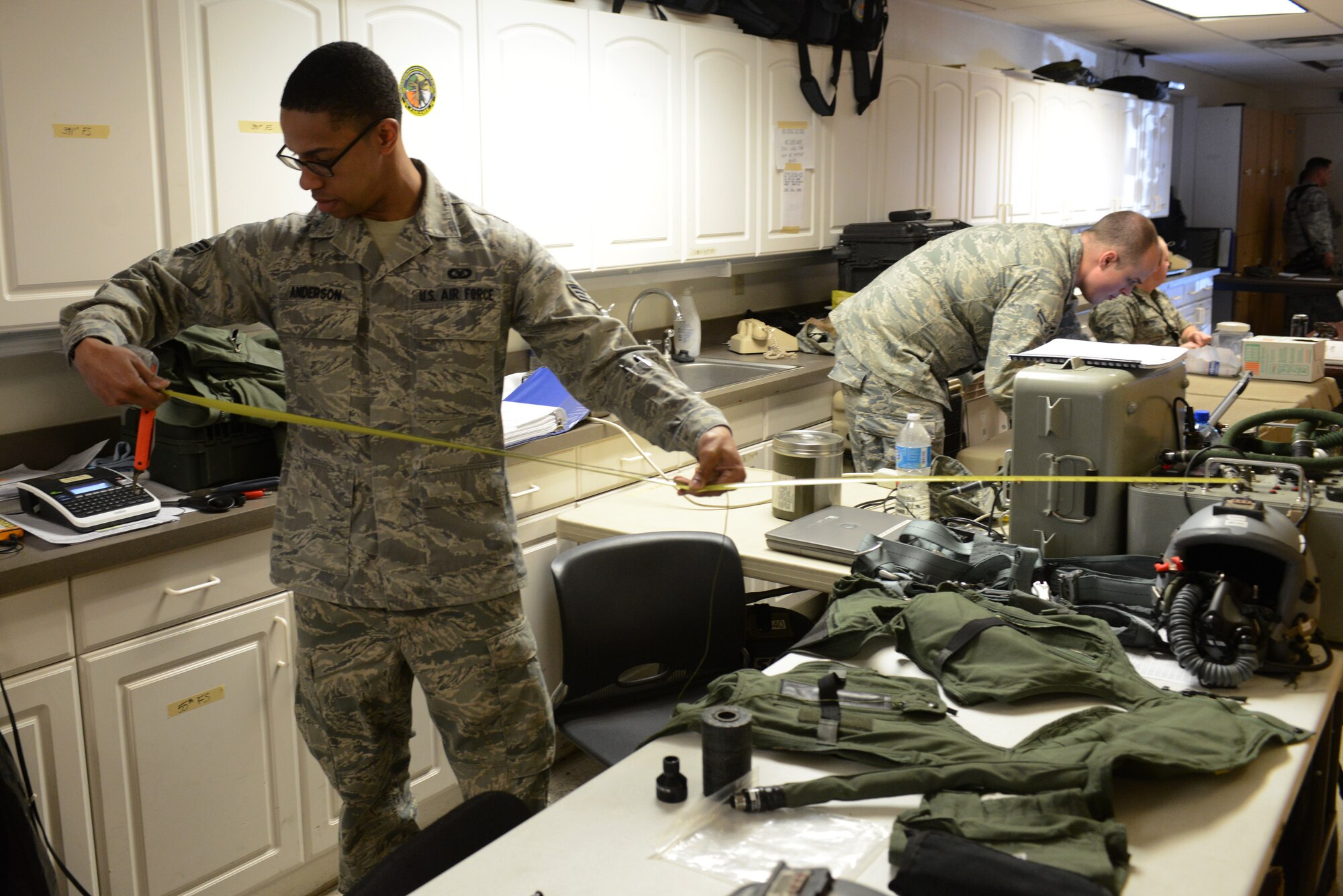 Senior Airman Albert Anderson, 366th Operation Support Squadron aircrew flight equipment technician, from Mountain Home Air Force Base, Idaho, measures cord to ensure it is the proper length for an F-15E Strike Eagle aircrew member before a sortie Feb. 3, 2014, at Nellis Air Force Base, Nev. More than 150 service members from Mountain Home AFB are currently on temporary duty assignment at Nellis AFB participating in the multinational combat exercise Red Flag 14-1. Red Flag gives aircrews and air support operations service members from various airframes, military services and allied countries an opportunity to integrate and practice combat operations. (U.S. Air Force photo by Senior Air Benjamin Sutton/Released)