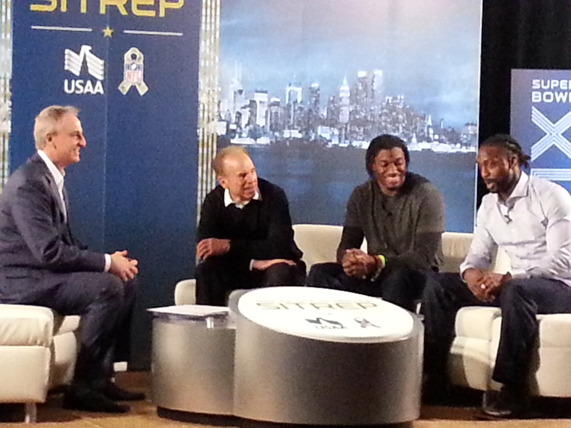Trey Wingo, USAA Salute to Service SITREP host, interviews NFL celebrities Roger Staubach, Robert Griffin III (RG3) and Charles Tillman in front of an audience packed with service members and their guests from Joint Base McGuire-Dix-Lakehurst, N.J., West Point and Gold Star Families Feb. 1, 2014, at the NFL House in Manhattan, N.Y. Attendees were invited by USAA to partake in the Super Bowl festivities in New York City, which included meet-and-greet sessions with Staubach, Griffin and Tillman and a catered lunch. (U.S. Air Force photo by Lemitchel King/Released)
