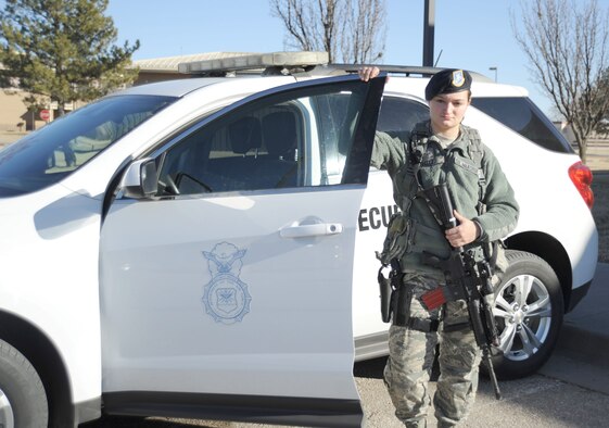Airman 1st Class Emily Reitz, 22nd Security Forces Squadron installation entry controller, poses by a patrol car at McConnell Air Force Base, Kan. Jan. 21, 2014. As an installation entry controller, Reitz is part of a team that ensures the safety of more than 3,000 people and millions of dollars of equipment. (U.S. Air Force photo/Airman 1st Class David Bernal Del Agua)