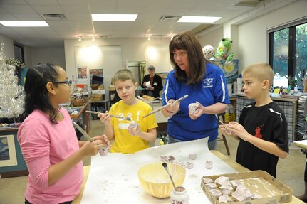 Randolph Elementary School students (from left) Amaya Sidwell, Jacob Malvaney and Braden Kroll create miniature clay hearts with Jodi Boshart, Randolph Elementary School art aide, Jan. 14 at Joint Base San Antonio-Randolph. (U.S. Air Force photo by Joel Martinez)
