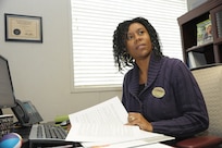 Angela Green, Military and Family Readiness Center school liaison officer, prepares documents for a customer Jan. 30 at Joint Base San Antonio-Randolph. (U.S. Air Force photo by Joel Martinez)