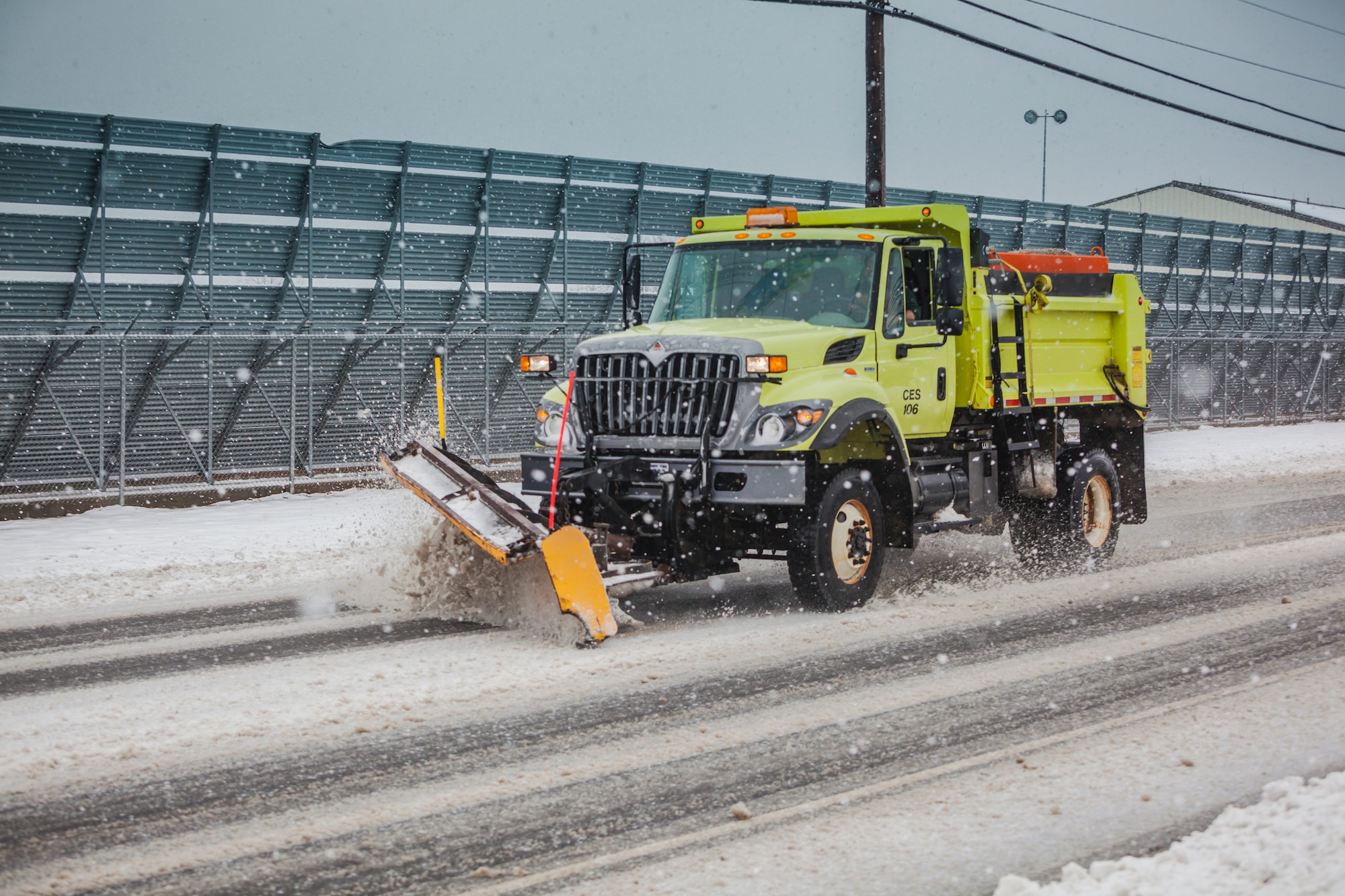 The 87th Civil Engineer Squadron's snow control team plows and salts the roads during a snowstorm to return to an operationally safe status Feb. 3, 2014, at Joint Base McGuire-Dix-Lakehurst, N.J. As soon as there is a report of a snow storm, the base implements the process of clearing the runways and aircraft parking ramps, all the roads and parking lots to return the base to normal operations. (U.S. Air Force photo by Wayne Russell/Released)