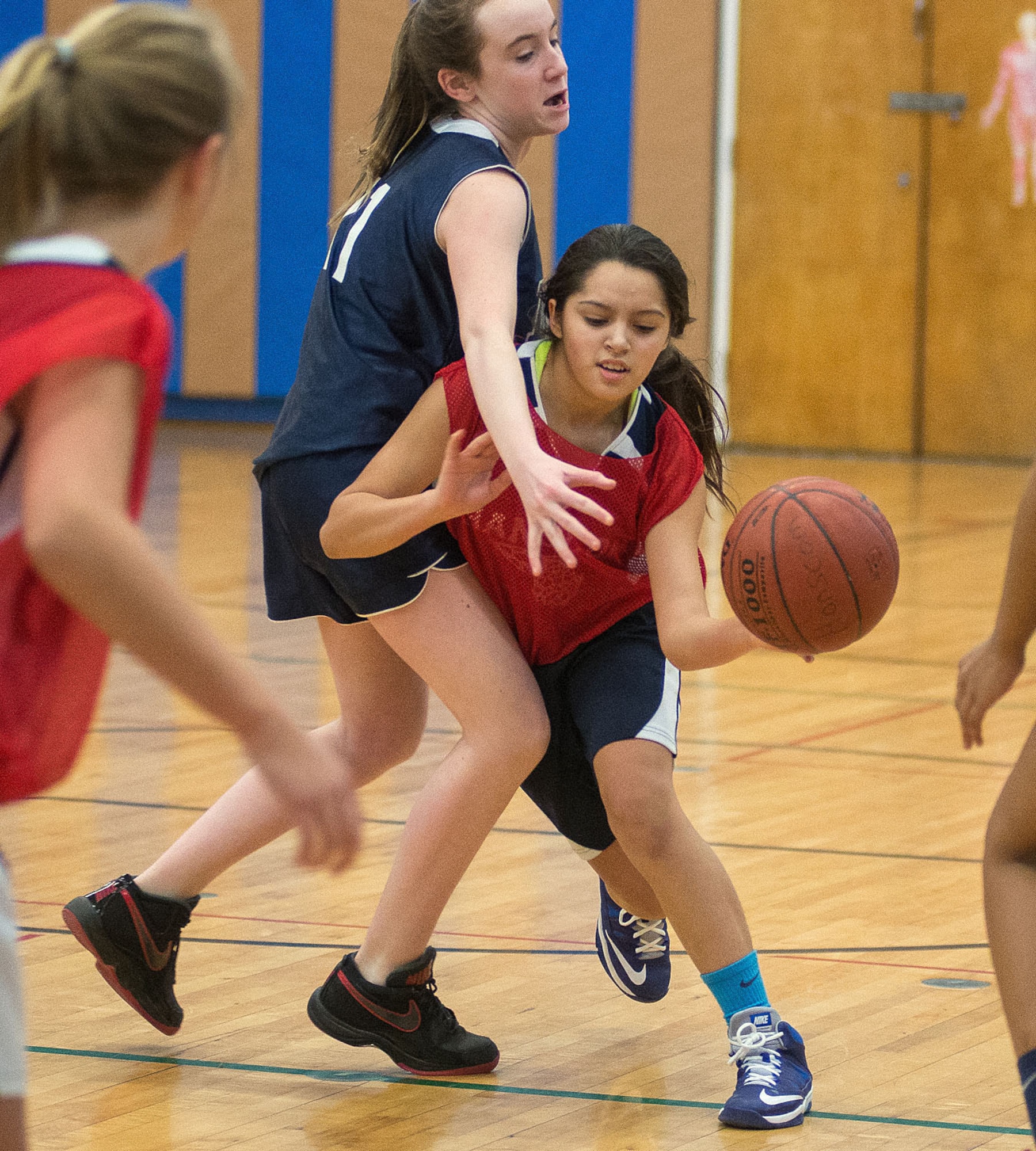 Alexandra Munoz from the Hanscom Middle School Falcons girls' basketball team drives past a defender in a game against Newton Day Middle School Jan 30. The Falcons lost the game, 31-21. (U.S. Air Force photo by Mark Herlihy)