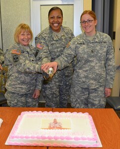 From left, U.S. Army Lt. Col. Sonya Shaw, deputy commander of Nursing and Patient Support Services, Col. Glenda J. Lock, McDonald Army Health Center commander and 1st Lt. Katherine Scanlon, Warrior Transition Unit nurse case manager, cut a celebratory cake during the Army Nurse Corps 113th Anniversary Celebration at Fort Eustis, Va., Feb. 3, 2014. Shaw and Scanlon represented the oldest and youngest Soldier present. The event aimed to honor the achievements of all nurses and celebrate their dedication and selflessness when caring for beneficiaries. (U.S. Army photo by Andrew J. Brown/Released)