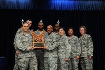 Lt. Col. James Gherdovich, 39th Logistics Readiness Squadron commander, center, accepts the Chief's Spirit Award from Col. Craig Wills, 39th Air Base Wing commander, on behalf of the 39th LRS during the promotion and awards ceremony Feb. 3, 2013, at Incirlik Air Base, Turkey. The award is presented to the squadron that displays the most squadron "spirit" during the ceremony. (U.S. Air Force photo by Airman 1st Class Nicole Sikorski/Released) 