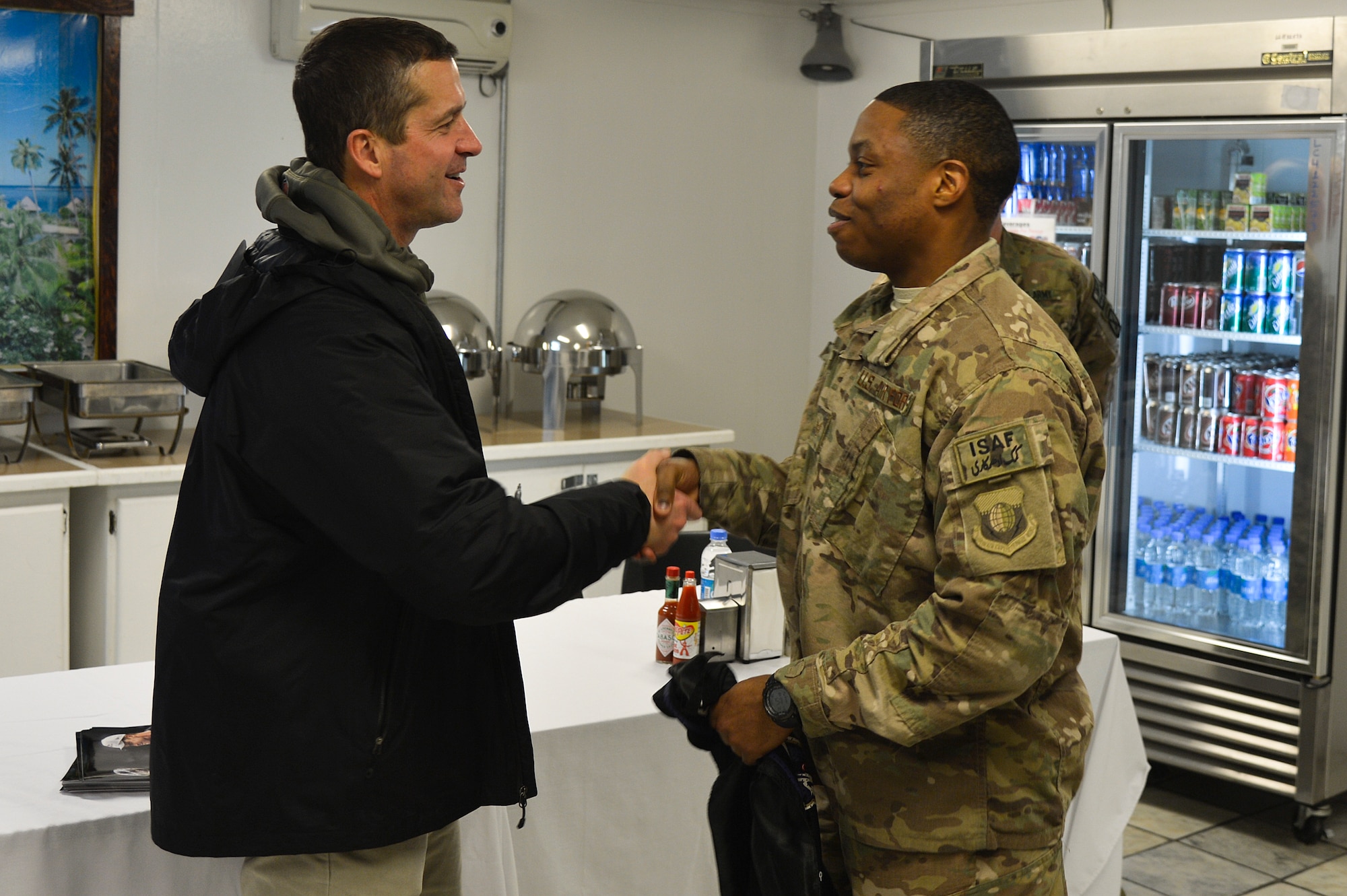 Baltimore Ravens head coach, John Harbaugh, shakes hands with U.S. Air Force Staff Sgt. Bryant Brown, 455th Expeditionary Logistics Readiness Squadron supply Airman, at Bagram Airfield, Afghanistan, Feb. 6, 2014. Harbaugh is known for his long support of the U.S. Armed Forces, with being a part of a 2009 tour to Baghdad, Iraq, and most recently, winning the NFL’s Salute to Service Award. (U.S. Air Force photo by Senior Airman Kayla Newman/Released)