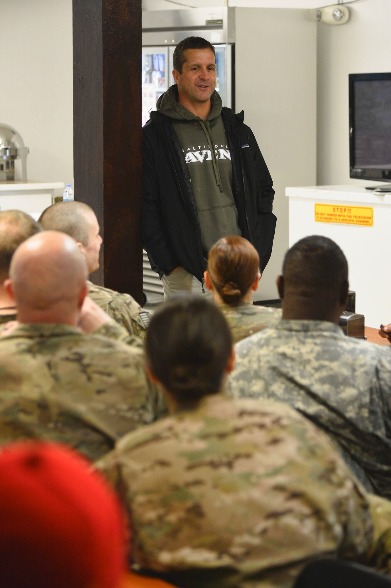 Baltimore Ravens head coach, John Harbaugh, talks with deployed Service members at Bagram Airfield, Afghanistan, Feb. 6, 2014. Harbaugh is on a tour through the Middle East with U.S. Army Chief of Staff Gen. Raymond Ordeirno. (U.S. Air Force photo by Senior Airman Kayla Newman/Released)