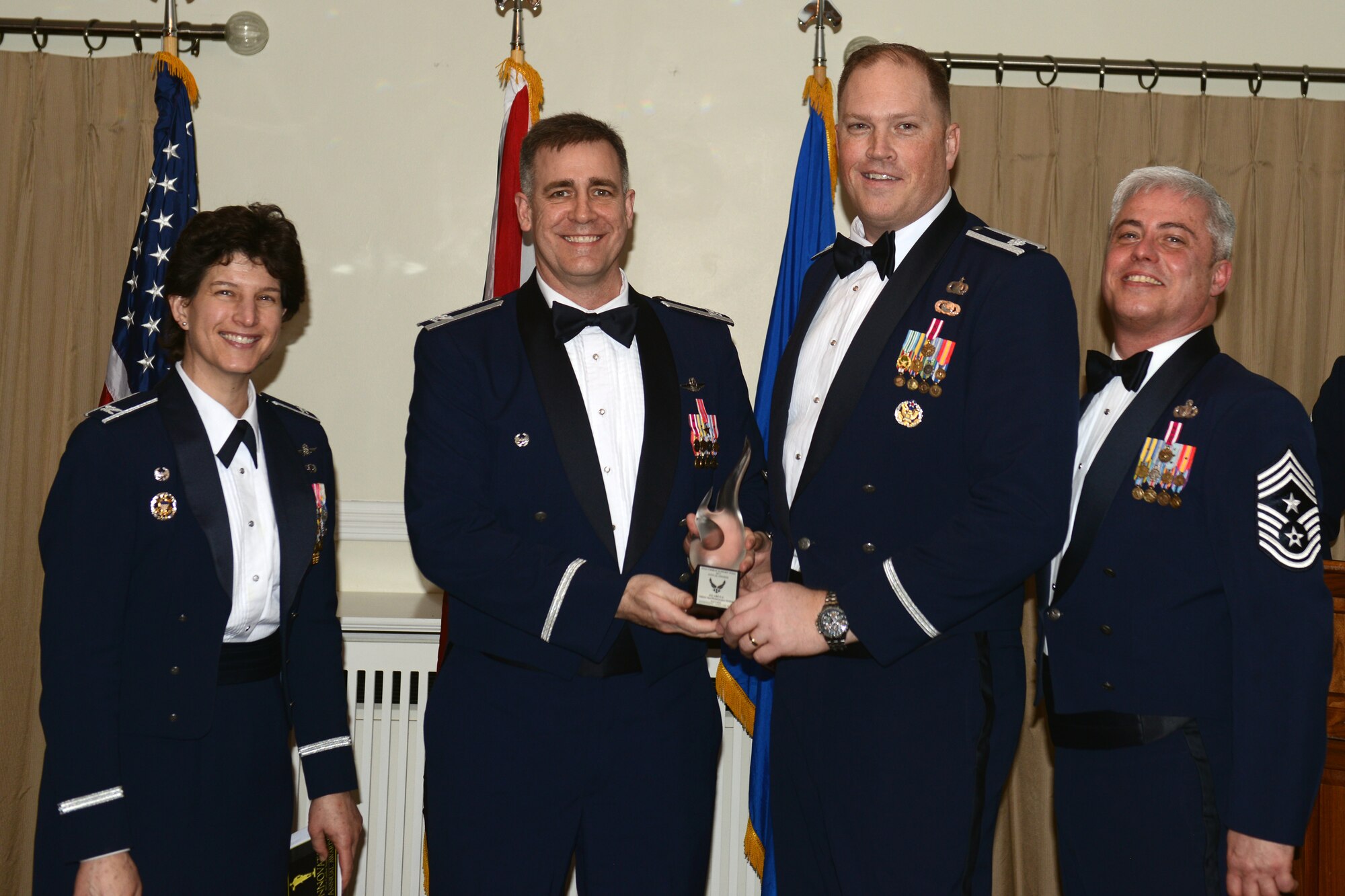 RAF ALCONBURY, United Kingdom - Col. Charles Hamilton, 422nd Air Base Group commander, accepts the 501st Combat Support Wing Innovator of the Year Award on behalf of the 422nd Air Base Squadron vehicle operations/maintenance section. The section compared the vehicle preventive maintenance inspection schedules in the Air Force Technical Order to the manufacturer's recommended schedules to determine a less costly method to maintain the government-owned vehicle fleet. Aligning the PMI schedule to the manufacturer's guidelines will save more than $154,000 during the first 30,000 miles of usage. Based on their findings, a case study is currently underway to evaluate changing the Air Force Technical Orders. (U.S. Air Force photo by Tech. Sgt. Chrissy Best)