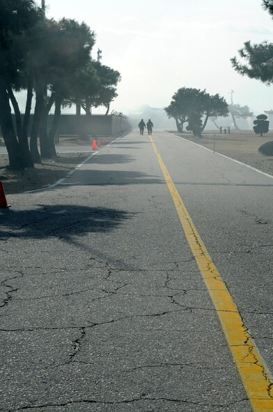 Members of the 8th Operations Support Squadron’s Airfield Management Operations and Weather Flight evacuate their building after a simulated mortar attack during exercise Beverly Midnight 14-01 at Kunsan Air Base, Republic of Korea, Feb. 6, 2014. This exercise was different from others; it focused more on asymmetric warfare, including snipers and high-value target explosions through the use of improvised explosive devices. (U.S. Air Force photo by Staff Sgt. Jessica Haas/Released)