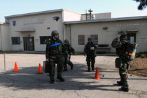 Eighth Operations Support Squadron Airfield Management Operations and Weather Flight Airmen evacuate their building after a simulated mortar attack during exercise Beverly Midnight 14-01 at Kunsan Air Base, Republic of Korea, Feb. 6, 2014. Simulated mortar attacks allow Airmen to demonstrate their ability to evacuate at a moment’s notice. (U.S. Air Force photo by Staff Sgt. Jessica Haas/Released)