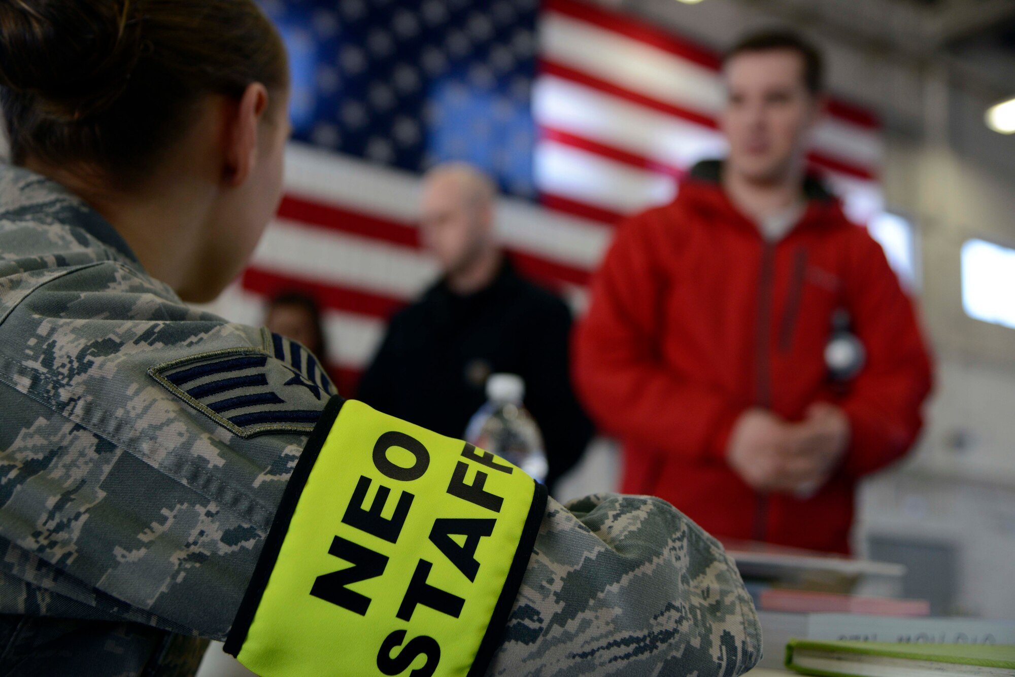 Air Force Staff Sgt. Jamie Barker, 673d Air Base Wing paralegal, prepares to help the next individual during an in-processing line at the noncombatant reception control center, Hangar 5, Joint Base Elmendorf-Richardson, Alaska, Feb. 5, 2014. There were more than five different agencies ready to assist the simulated evacuees. (U.S. Air Force photo/Staff Sgt. Sheila deVera)